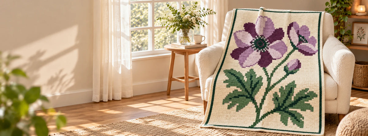 Purple anemone blanket design displayed on a cream chair